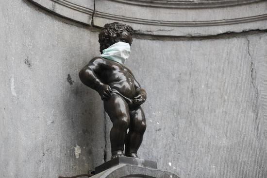 The Manneken Pis (Little Pissing Man) wearing a mask is seen in Brussels, Belgium, April 13, 2020. (Xinhua/Zheng Huansong)