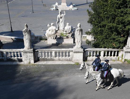 Two mounted police patrol in Rome, Italy, April 11, 2020. (Photo by Alberto Lingria/Xinhua)