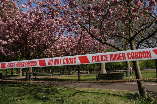 An area is taped off to prevent people getting into the blossoms in Greenwich Park in London, Britain, on April 13, 2020. (Photo by Tim Ireland/Xinhua)