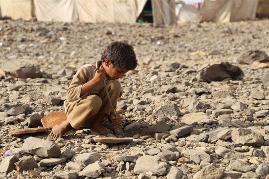 A displaced child plays at a displaced camp in Haradh District in Hajjah province, Yemen, April 7, 2020. (Photo by Mohammed Alwafi/Xinhua)