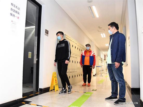 Teachers attend an epidemic prevention and control drill at the Affiliated High School of Peking University in Beijing, capital of China, April 22, 2020. (Xinhua/Ren Chao)