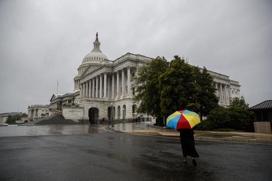 A person walks towards the U.S. Capitol building in Washington D.C., the United States on April 30, 2020. (Photo by Ting Shen/Xinhua)
