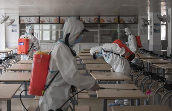 Firefighters disinfect the canteen in Wuhan No. 23 Middle School in Wuhan, central China's Hubei Province, April 22, 2020. (Xinhua/Fei Maohua)