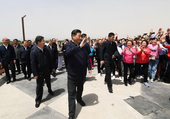Chinese President Xi Jinping, also general secretary of the Communist Party of China Central Committee and chairman of the Central Military Commission, waves to citizens during his visit to a section of the Fenhe River in Taiyuan, capital city of north China's Shanxi Province, May 12, 2020. Xi inspected Taiyuan on Tuesday. (Xinhua/Xie Huanchi)