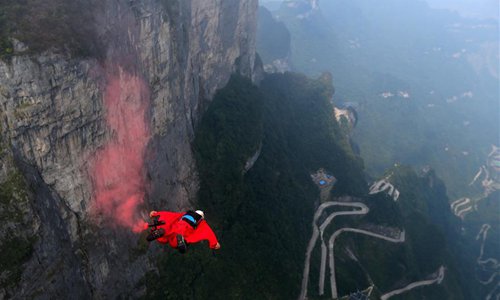 A wingsuit flyer glides through the air during a wingsuit flying competition held at the Tianmen Mountain scenic spot in Zhangjiajie, central China's Hunan Province, Sept. 14, 2018. (Xinhua/Zhou Guoqiang)