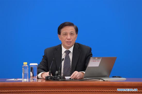 Zhang Yesui, spokesperson for the third session of the 13th National People's Congress (NPC), attends a press conference via video link in Beijing, capital of China, May 21, 2020. The NPC, China's top legislature, held a press conference Thursday night ahead of its annual session in Beijing. Zhang Yesui took questions from Chinese and foreign reporters on the agenda of the session and work of the NPC via video link. (Xinhua/Li He)