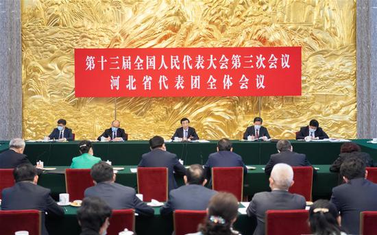 Wang Huning, a member of the Standing Committee of the Political Bureau of the Communist Party of China (CPC) Central Committee and a member of the Secretariat of the CPC Central Committee, joins deputies from Hebei Province in group deliberation at the third session of the 13th National People's Congress (NPC) in Beijing, capital of China, May 22, 2020. (Xinhua/Zhai Jianlan)