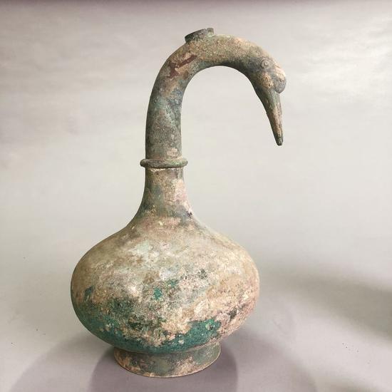 Photo taken on May 22, 2020 shows a 2,000-year-old bronze pot with a curved neck in the shape of a swan. The pot, freshly unearthed in central China's Henan Province, contains more than 3,000 ml of unknown liquid. (Xinhua/Li Lijing)
