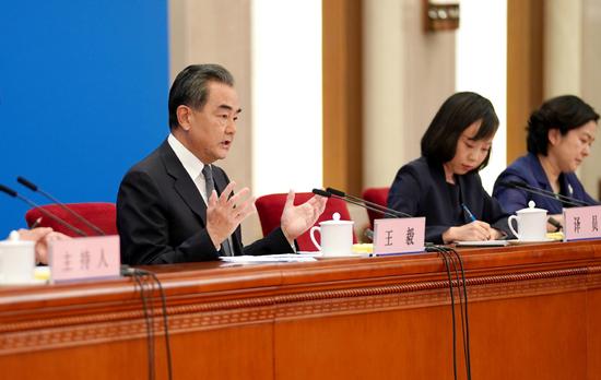State Councilor and Foreign Minister Wang Yi answers a question at a news conference on the sidelines of the annual national legislative session in Beijing on May 24, 2020. (Photo/Xinhua)