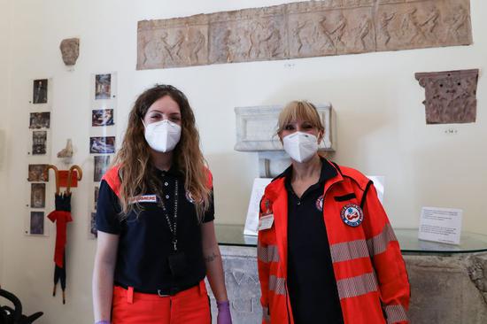 The staff prepare to test the body temperature and disinfect the hands of visitors at the entrance of the Colonna Palace in Rome, Italy, May 23, 2020. (Xinhua/Cheng Tingting)