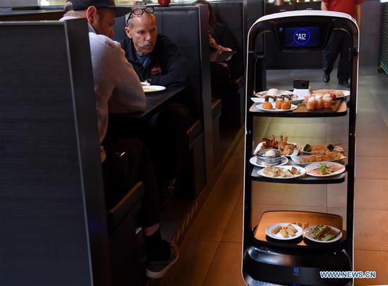 Robot delivers meals to customer at Asian restaurant in Vienna, Austria