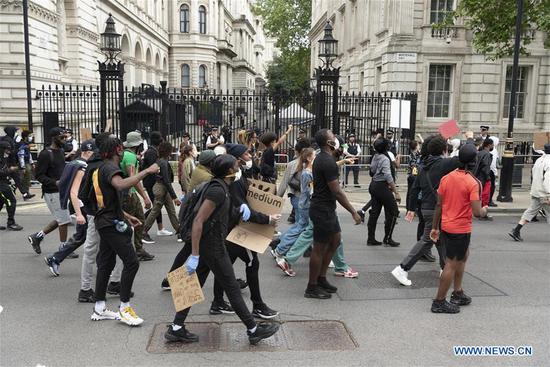 People take part in a demonstration in London, Britain, on June 3, 2020. Thousands of people gathered in London on Wednesday to protest over the death of George Floyd, an unarmed black man suffocated to death by a white police officer in the mid-western U.S. state of Minnesota last week. (Photo by Ray Tang/Xinhua)