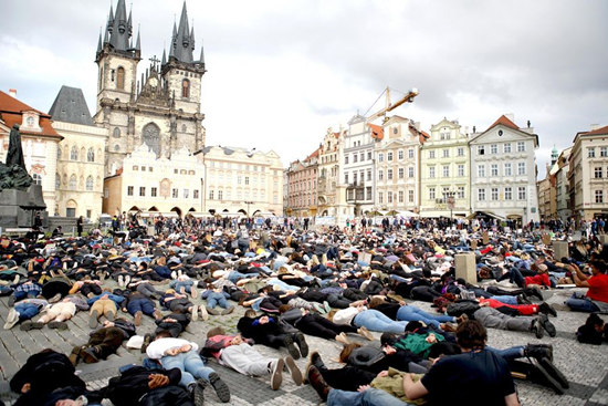 People lie down on the ground during a protest over the death of George Floyd in Prague, Czech Republic, June 6, 2020. Several hundred demonstrators on Saturday gathered in the old town square of Prague to protest against police brutality and racism in the United States. (Photo by Dana Kesnerova/Xinhua)