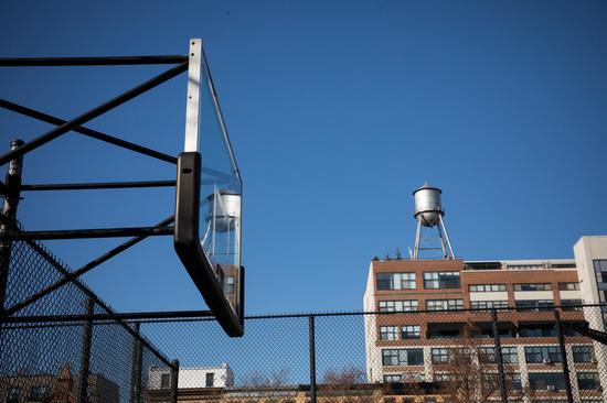 A basketball backboard stands without hoop, after it was removed to prevent people from spreading coronavirus by gathering, at Dean Playground in the Brooklyn borough of New York, the United States, on March 27, 2020. (Photo by Michael Nagle/Xinhua)