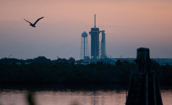 A SpaceX Falcon 9 rocket with Crew Dragon spacecraft onboard is seen on the launch pad at sunrise, at NASA's Kennedy Space Center in Florida, the United States, May 27, 2020. (Joel Kowsky/NASA/Handout via Xinhua)