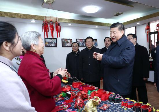 Chinese President Xi Jinping (R, front), also general secretary of the Communist Party of China (CPC) Central Committee and chairman of the Central Military Commission, buys a herbal sachet made by the 80-year-old villager Wang Xiuying in Mazhuang Village of Xuzhou, east China's Jiangsu Province, Dec. 12, 2017. (Xinhua/Ju Peng)
