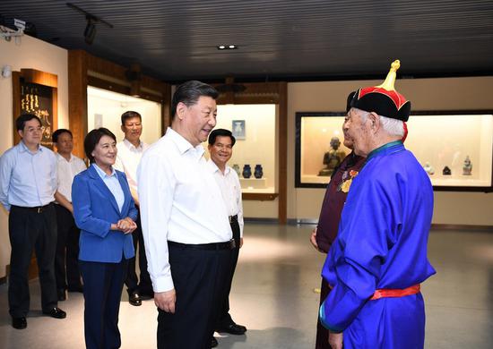 Chinese President Xi Jinping, also general secretary of the Communist Party of China (CPC) Central Committee and chairman of the Central Military Commission, talks with intangible cultural heritage inheritors to the King Gesar epic at Chifeng Museum in Chifeng City, China's Inner Mongolia Autonomous Region, July 15, 2019. (Xinhua/Xie Huanchi)