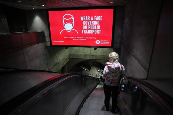 A person takes the escalator at London Bridge Station in London, Britain on June 10, 2020. (Photo by Tim Ireland/Xinhua)