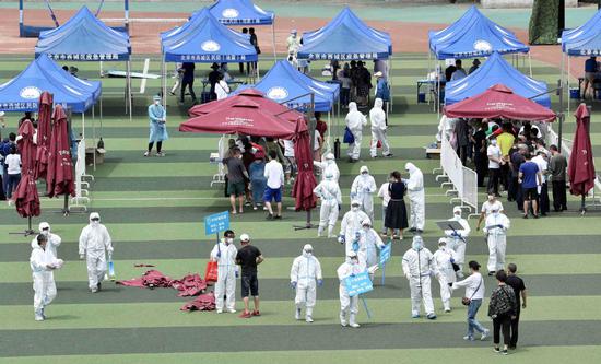People line up for nucleic acid testing on June 15, 2020 at Guang'an Gymnasium in Xicheng District, Beijing. Beijing is organizing nucleic acid tests for 90,000 residents to curb a new cluster of local COVID-19 infections. (Photo by Zou Hong/chinadaily.com.cn)