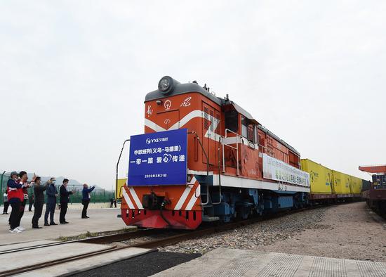 A China-Europe freight train bound for Madrid of Spain, which carries two containers of medical supplies as well as other goods, departs the city of Yiwu, east China's Zhejiang Province, March 21, 2020.(Photo by Gong Xianming/Xinhua)