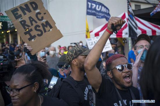 Protesters take part in a demonstration in Tulsa, Oklahoma, the United States, on June 20, 2020. U.S. President Donald Trump held his first rally in more than three months in Tulsa on Saturday evening, amid COVID-19 concerns and a national reckoning over racism. There were multiple groups of demonstrators with varying viewpoints in the area adjacent to the rally. (Photo by Alan Chin/Xinhua)