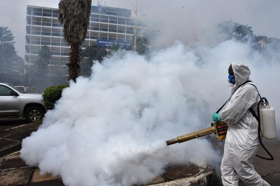 A personnel fumigates Ministry of Health's car parked in Nairobi, capital of Kenya, June 13, 2020. (Xinhua/Fred Mutune)