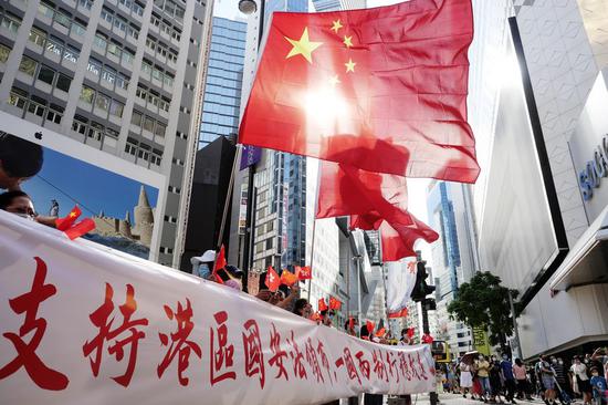 Hong Kong citizens celebrate the passage of the Law of the People's Republic of China on Safeguarding National Security in the Hong Kong Special Administrative Region (HKSAR) in Causeway Bay of south China's Hong Kong, June 30, 2020. (Xinhua/Wang Shen)