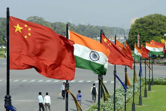 Indian and Chinese national flags flutter side by side at the Raisina hills in New Delhi, India, on Sept. 16, 2014. (Xinhua/Partha Sarkar)