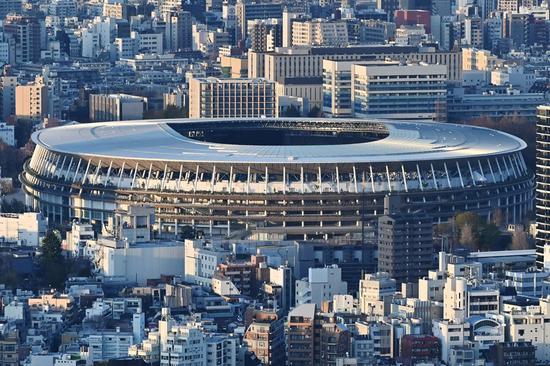 The newly-built Japan National Stadium, the main venue for the 2020 Olympic Games, is pictured from a highrise viewing area in Tokyo on March 25, 2020, the day after the historic decision to postpone the 2020 Tokyo Olympic Games. (Photo/Xinhua)