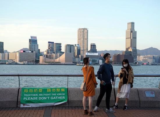 A poster reminding people not to gather is seen in Hong Kong, south China, April 12, 2020. (Xinhua/Li Gang)