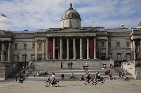 People sit on steps of the National Gallery in London, Britain, on May 17, 2020. (Photo by Tim Ireland/Xinhua)