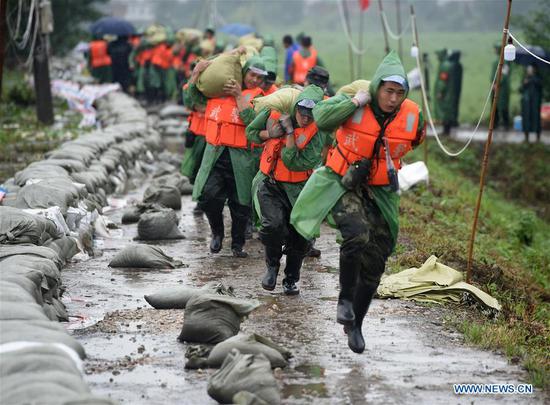 Armed police officers reinforce Sanlongwei section of levee in Wuhu, E China