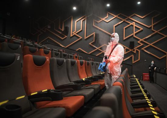 A staff member conducts disinfection in a cinema in Wuhan, central China's Hubei Province, July 20, 2020. (Xinhua/Xiao Yijiu)