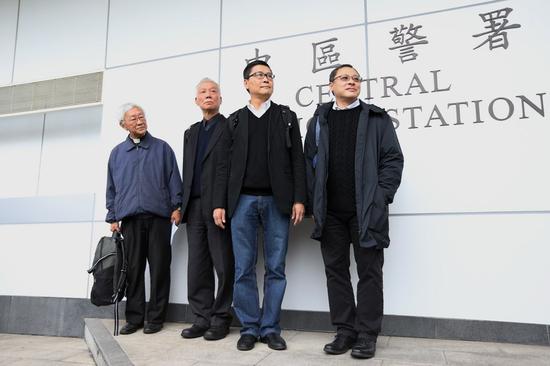 Benny Tai (R1) surrenders himself to a police station in Hong Kong, south China, Dec. 3, 2014. (Xinhua/Lui Siu Wai)