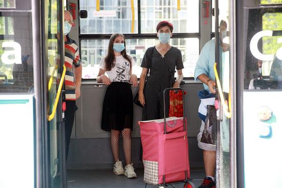 Passengers wearing face masks are seen on a bus in Bucharest, Romania, on August 1, 2020. Mask-wearing is being made mandatory in crowded outdoor public places in nearly half of Romania starting Saturday. (Photo by Gabriel Petrescu/Xinhua)