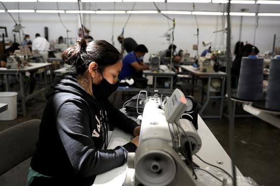 Workers make face masks at a face mask factory transformed from a 16,000 square-foot apron factory amid the COVID-19 pandemic in the City of Vernon, Los Angeles County, California, the United States, April 16, 2020. (Xinhua)