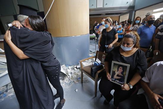 People mourn for a victim of explosions in a hospital in Beirut, Lebanon, on Aug. 6, 2020. (Xinhua/Bilal Jawich)