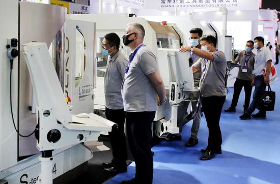 People visit the China Machine Tool Exhibition with nearly 1,500 manufacturers from home and abroad participating at the National Exhibition and Convention Center (NECC) in Shanghai, east China, July 1, 2020. (Xinhua/Fang Zhe)