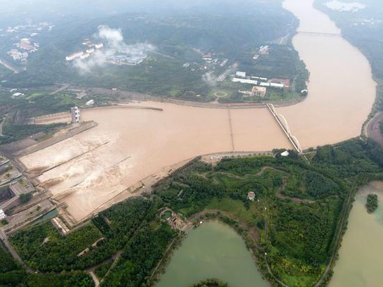 Aerial photo taken on July 19, 2020 shows water gushing out from sluiceways of the Xiaolangdi Reservoir on the Yellow River in central China's Henan Province. (Photo by Jia Fangwen/Xinhua)