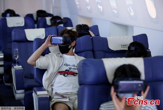 Boarding fake planes to take virtual vacations around the world