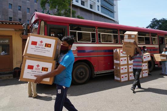 Staff members transfer face masks donated to bus drivers by the Chinese embassy in Sri Lanka in Colombo, Sri Lanka, Aug. 17, 2020. (Xinhua/Tang Lu)