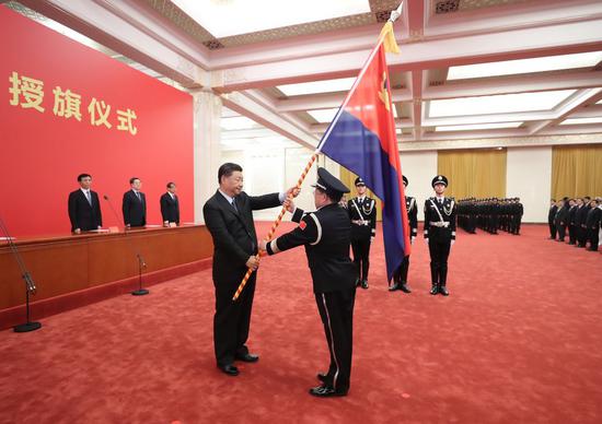 Chinese President Xi Jinping, also general secretary of the Communist Party of China Central Committee and chairman of the Central Military Commission, confers the police flag on China's police force during a ceremony at the Great Hall of the People in Beijing, capital of China, Aug. 26, 2020. (Xinhua/Ju Peng)