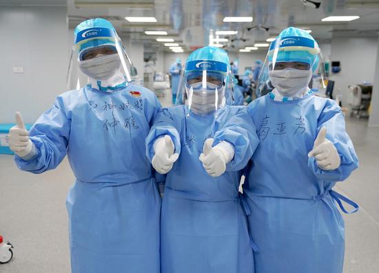 Nurses born in the 1990s and 1980s pose for a photo at the makeshift Huoshenshan (Fire God Mountain) Hospital in Wuhan, capital of central China's Hubei Province, March 20, 2020. (Xinhua/Wang Yuguo)