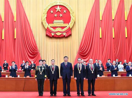 Chinese President Xi Jinping, also general secretary of the Communist Party of China Central Committee and chairman of the Central Military Commission, presents medals to the recipient of the Medal of the Republic Zhong Nanshan (2nd R, front), and recipients of the national honorary title, 