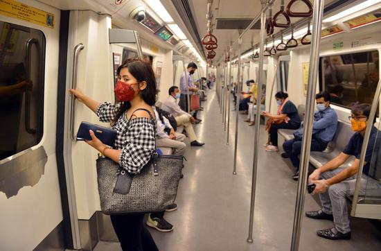 Passengers maintain social distance inside a compartment of metro train in New Delhi, India, on Sept. 7, 2020. (Photo by Partha Sarkar/Xinhua)
