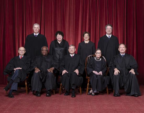 Associate Justice Ruth Bader Ginsburg is seen seated second from right in the front row of a group photo of the U.S. Supreme Court's nine Justices. Prior to Ginsburg's decease, the U.S. Supreme Court was made up of nine Justices: one Chief Justice and eight Associate Justices. (Photo source: supremecourt.gov)