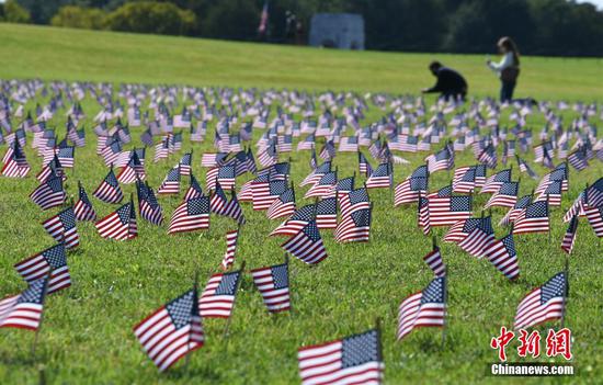 Thousands of flags cover the National Mall to memorialize COVID-19 deaths