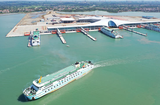 The country's largest roll-on, roll-off passenger harbor starts operation at Xuwen port area of Zhanjiang, Guangdong province, on Saturday, reducing the travelling time to the island province of Hainan. (Photo by Guo Longbi / For China Daily)