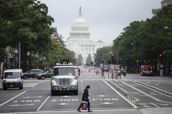 A man crosses a street near the Capitol Building in Washington, D.C., the United States, Sept. 9, 2020. (Xinhua/Liu Jie)