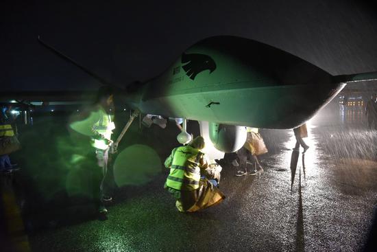 Tech-professionals conduct the pre-flight examinations on Wing Long-2. (Photo provided to Xinhua)